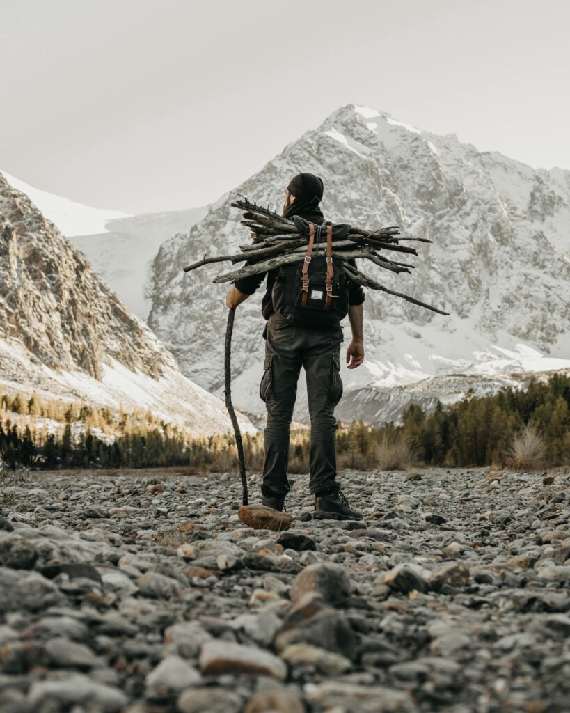 Huy standing with sticks Man in nature with sticks
